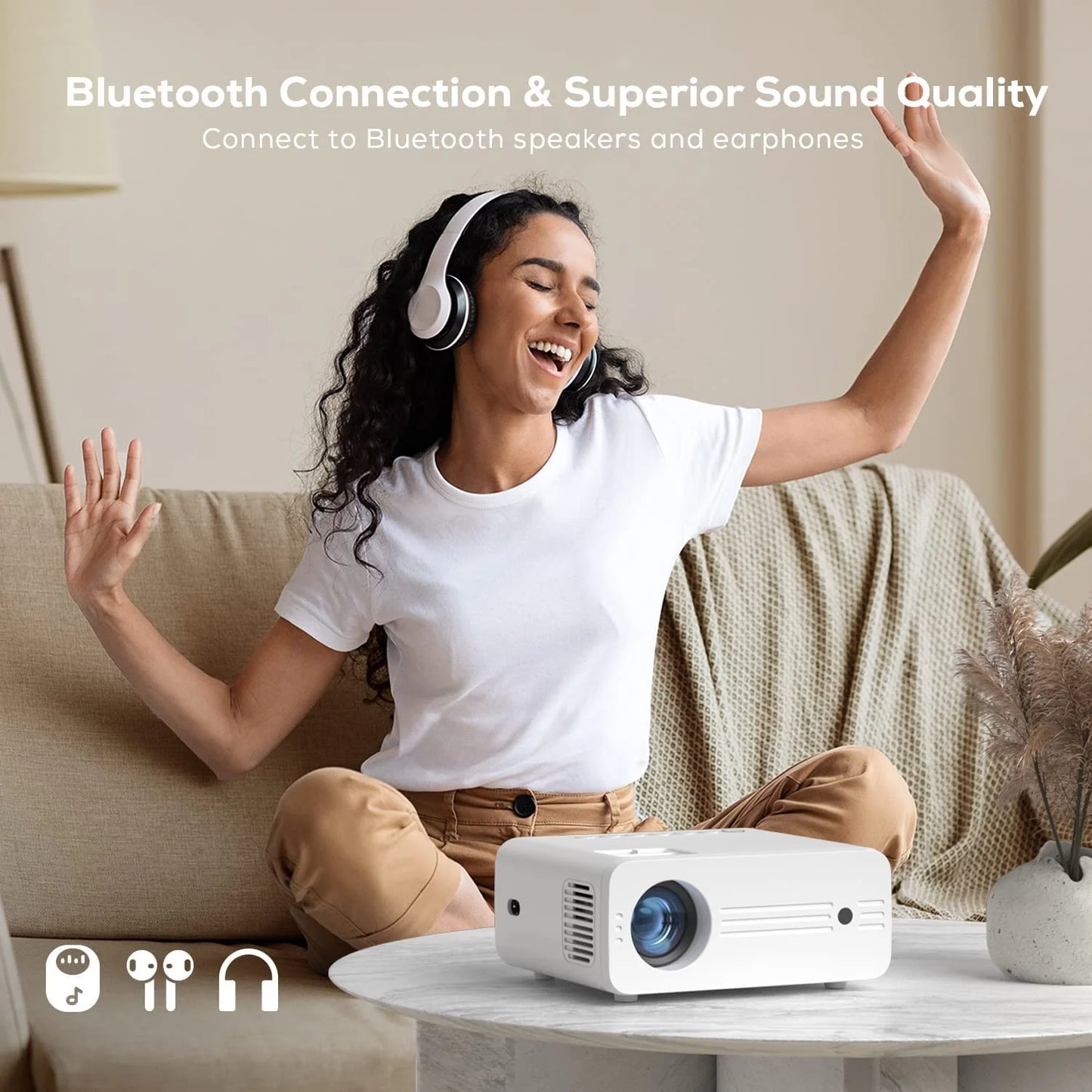 A women enjoying the bluetooth sound connection feature of her projector.
